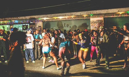 Kingston, Jamaica - June 26, 2008: Crowd enjoying reggae/dancehall music and dancing at ghetto street party, called "Passa Passa". "Passa Passa" was a weekly party which was held at Tivoli Gardens on Wednesday nights and ended around 8 am next morning, now it is history already.